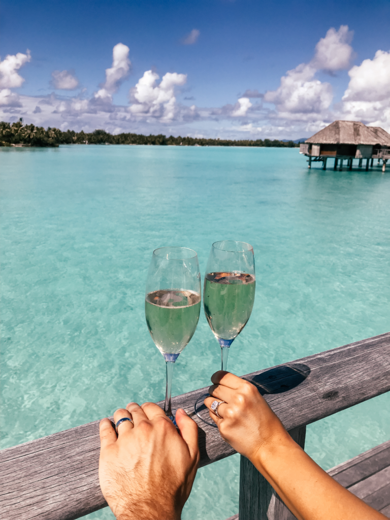four seasons bora bora honeymoon travel cheers champagne lagoon view